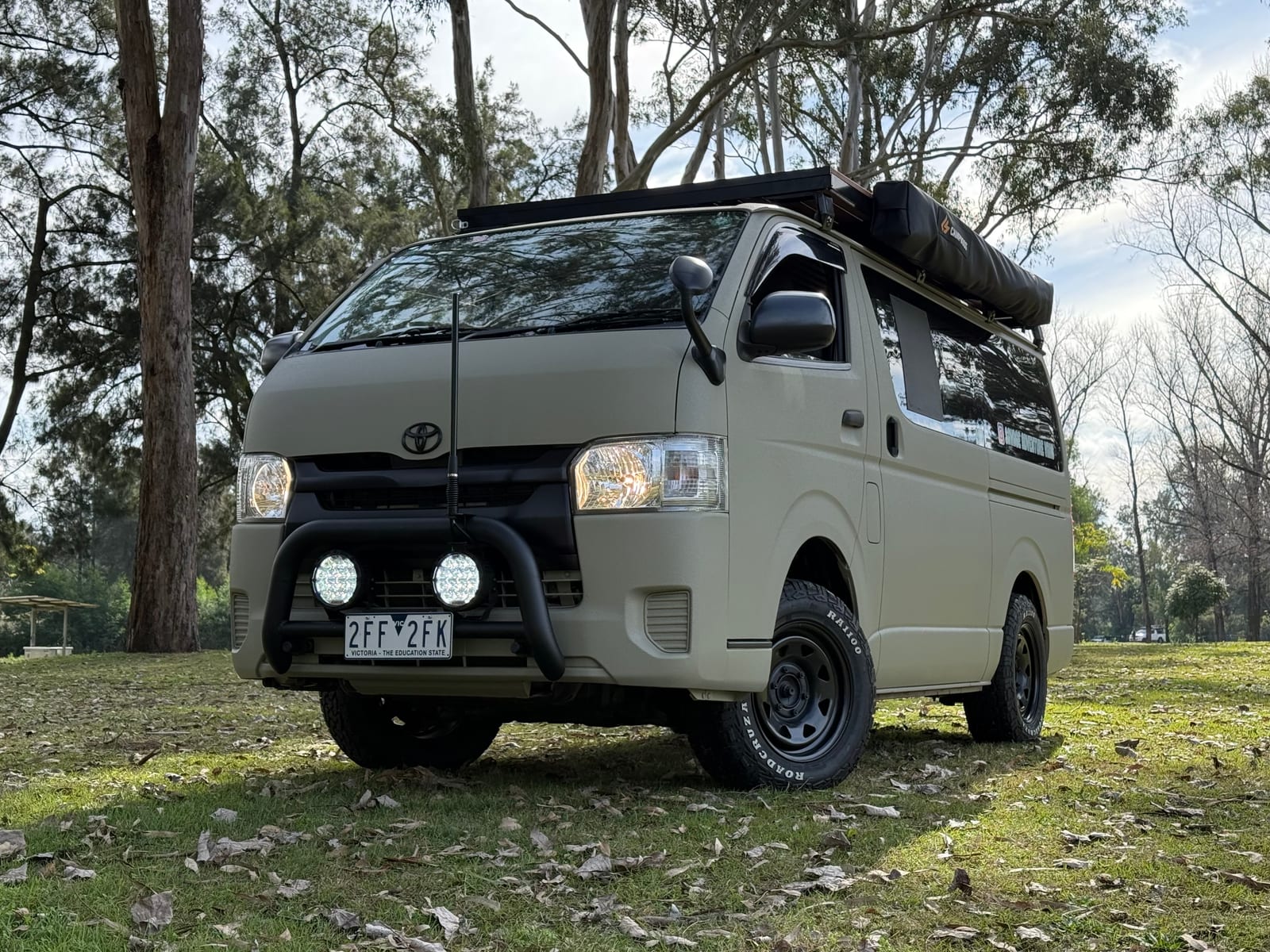 Khaki 4×4 Hiace — Front three-quarter, bullbar and spotlights