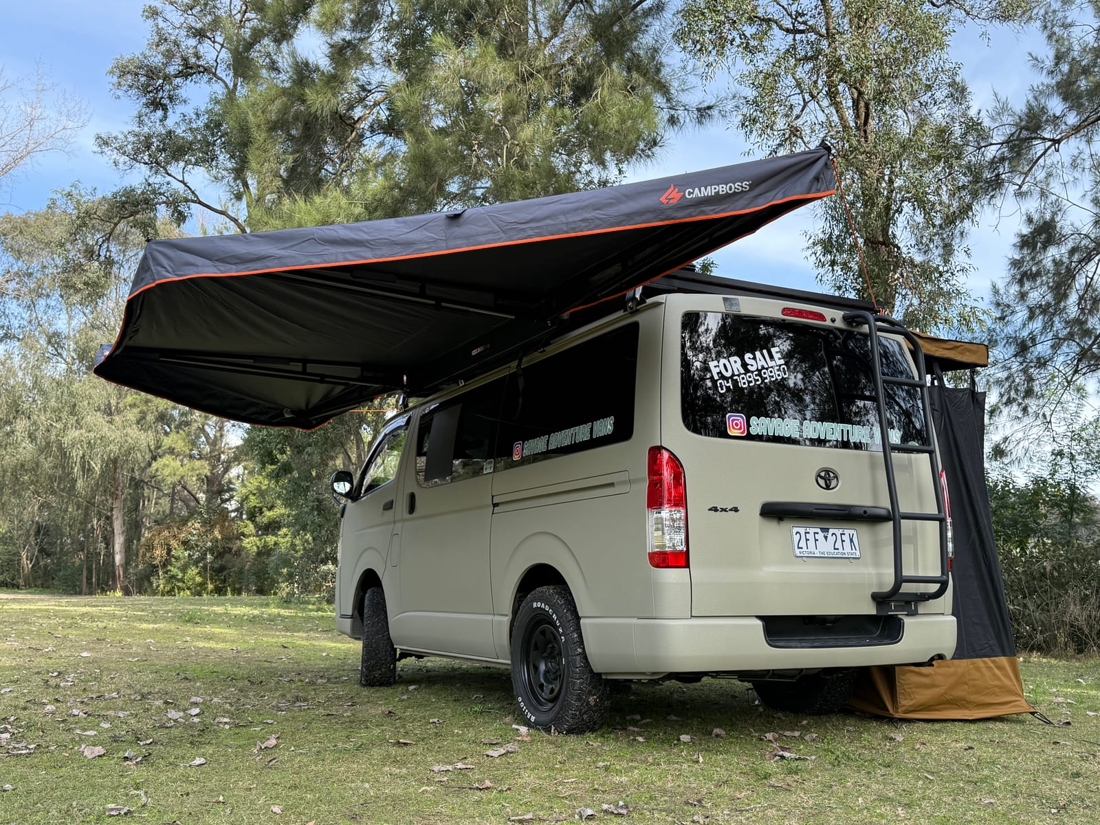 Khaki 4×4 Hiace — Rear quarter with the awning extended