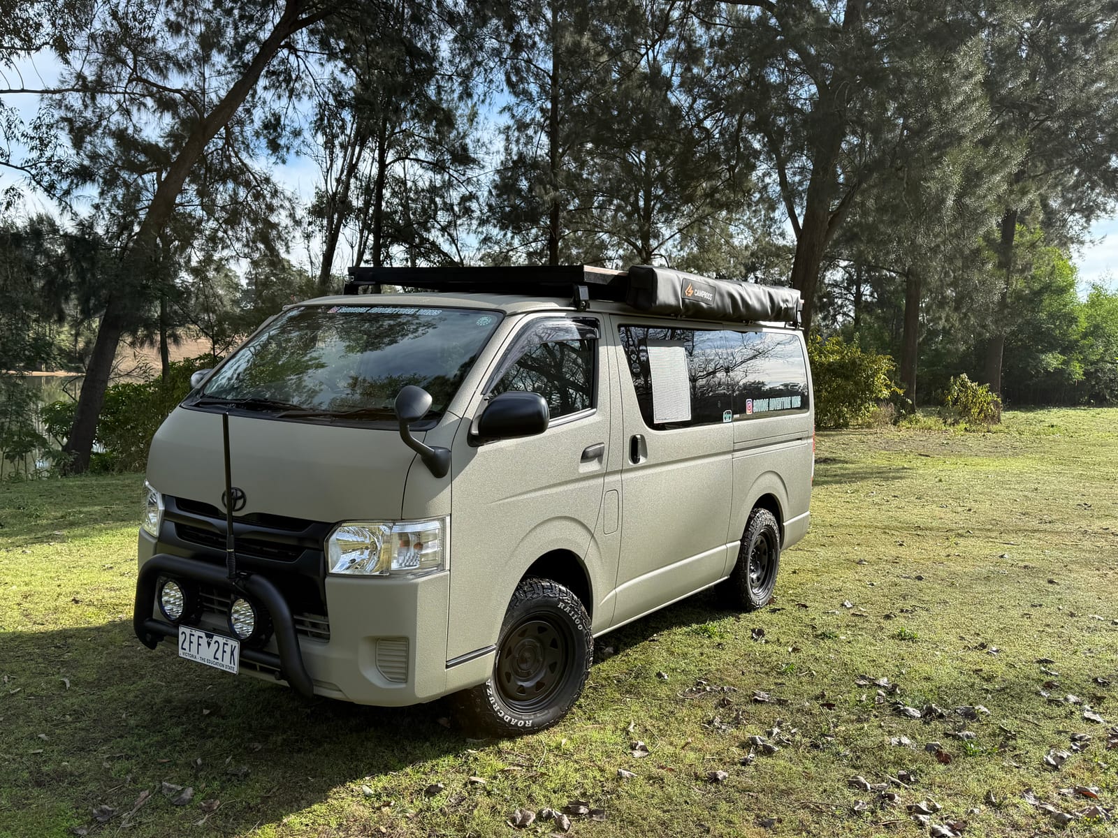 Khaki 4×4 Hiace — Nose on, in the trees
