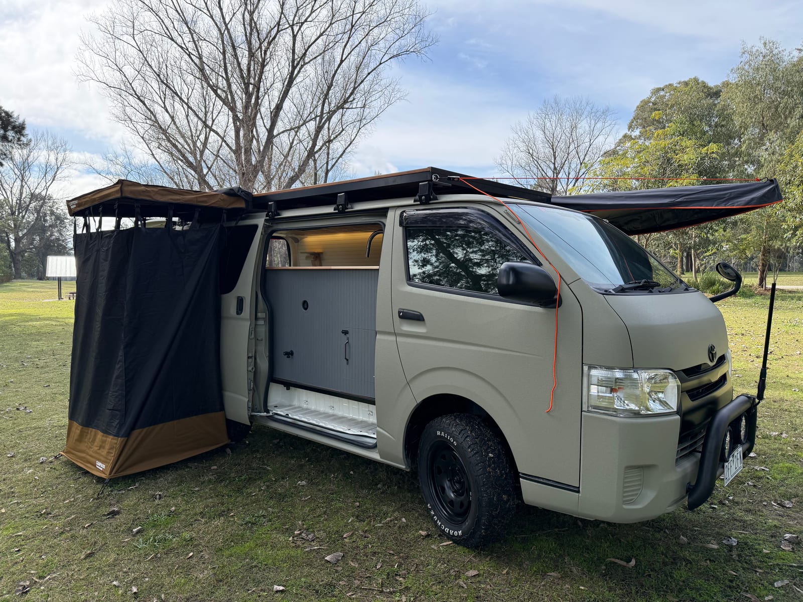 Khaki 4&times;4 Hiace &mdash; Ensuite tent up against the side door