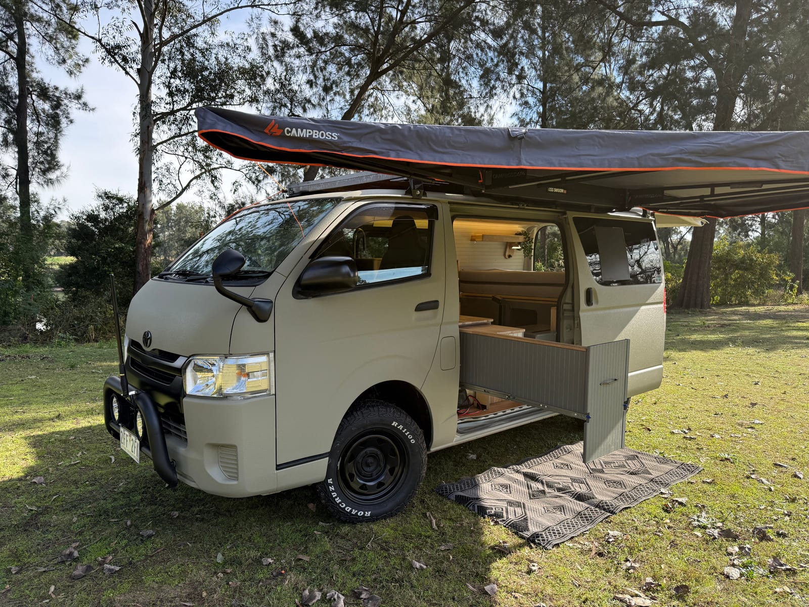 Khaki 4&times;4 Hiace &mdash; Side on, awning over the door