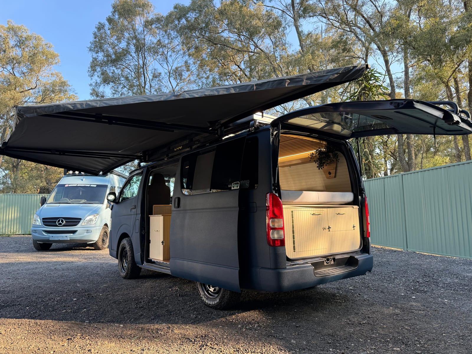 Navy 4×4 Hiace — Awning out, side doors open