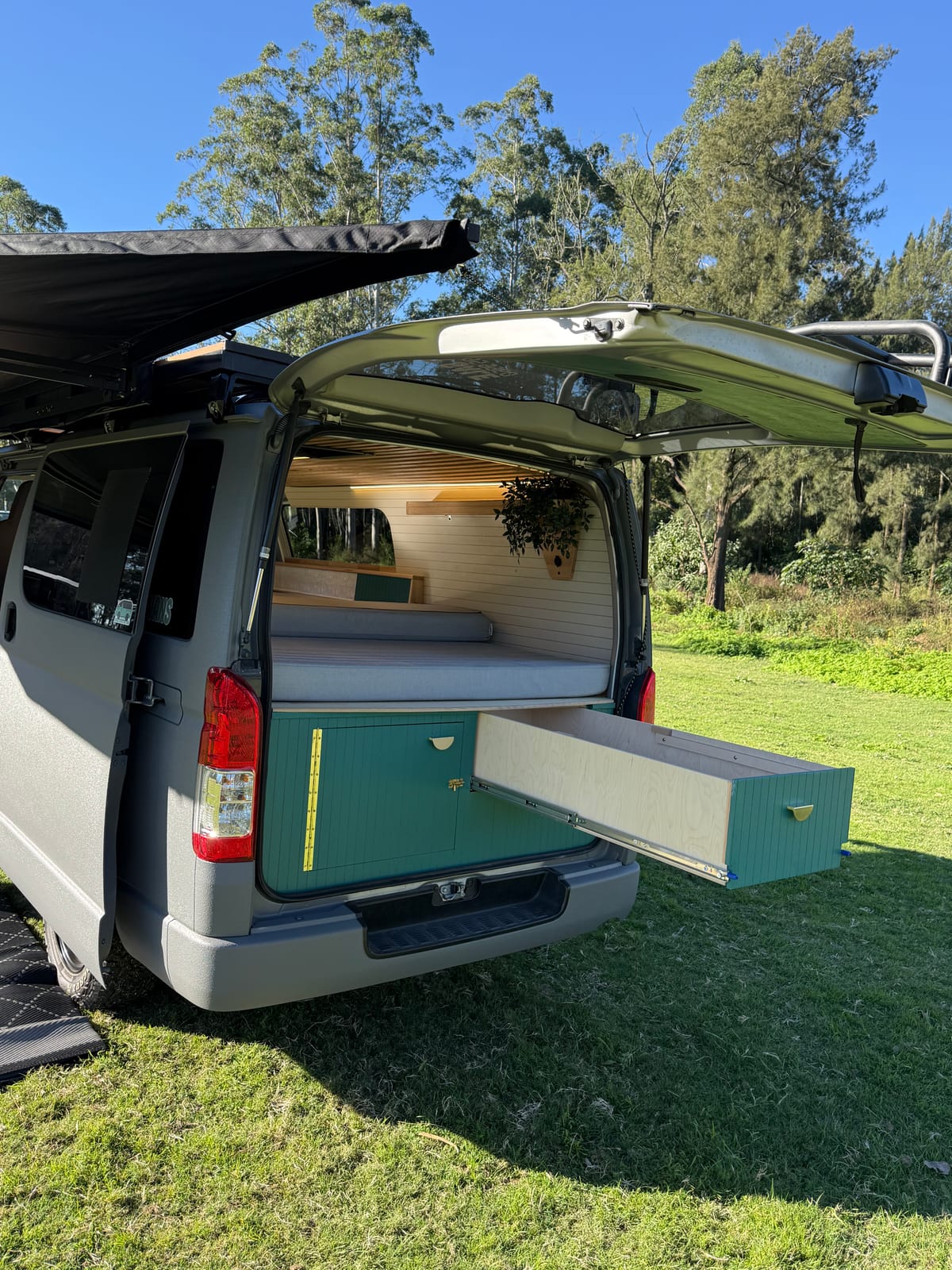 Teal Galley Hiace &mdash; Rear quarter under the awning